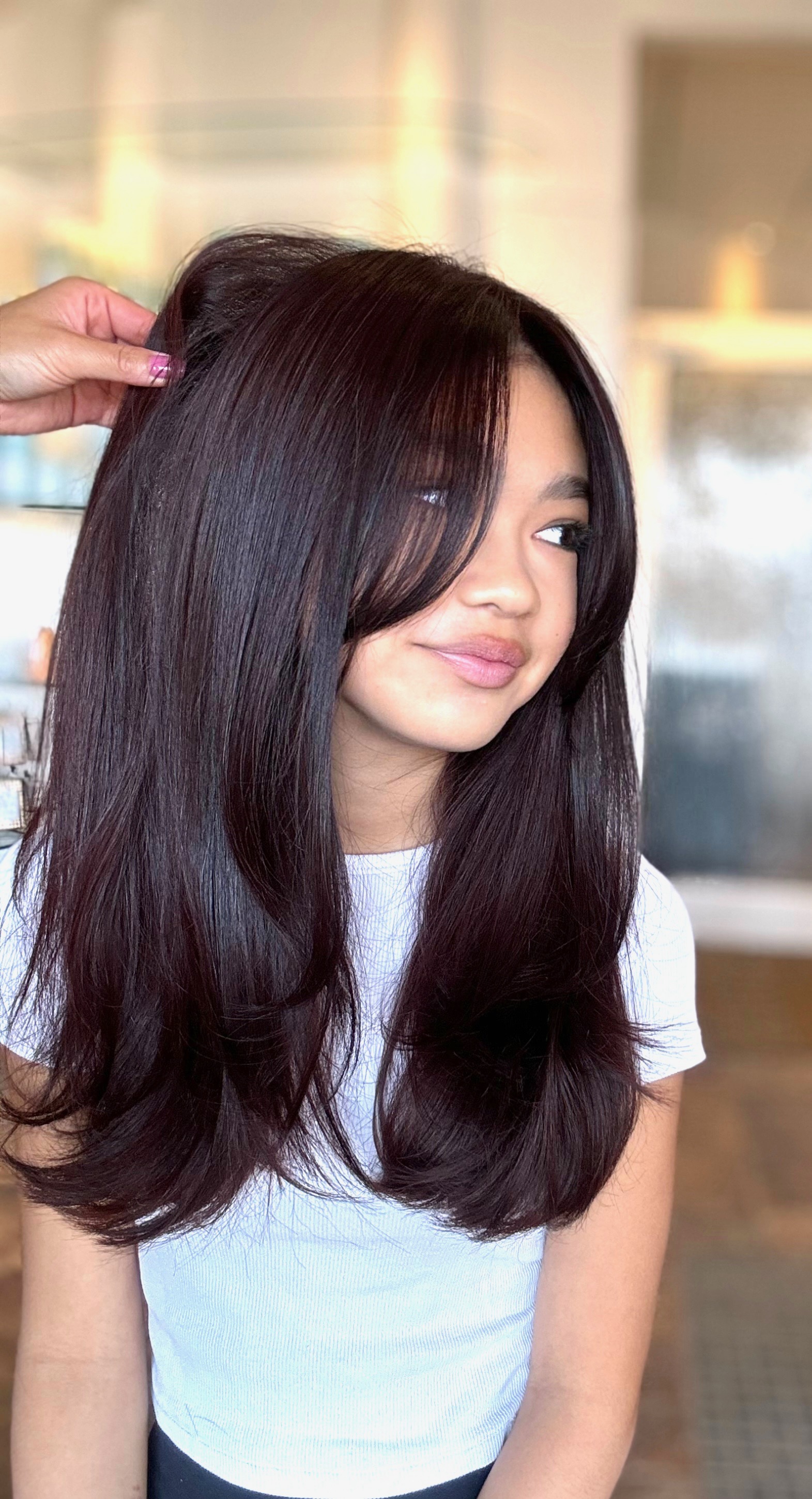 Glossy brunette cut with face-framing layers